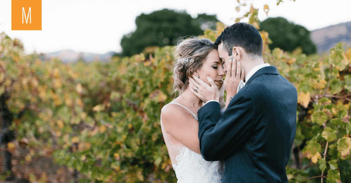 An intimate moment of a couple embracing at Valley of the Moon, Beautiful vines behind them!