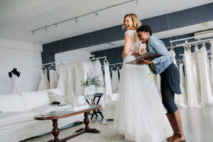 bride getting fitted in wedding dress