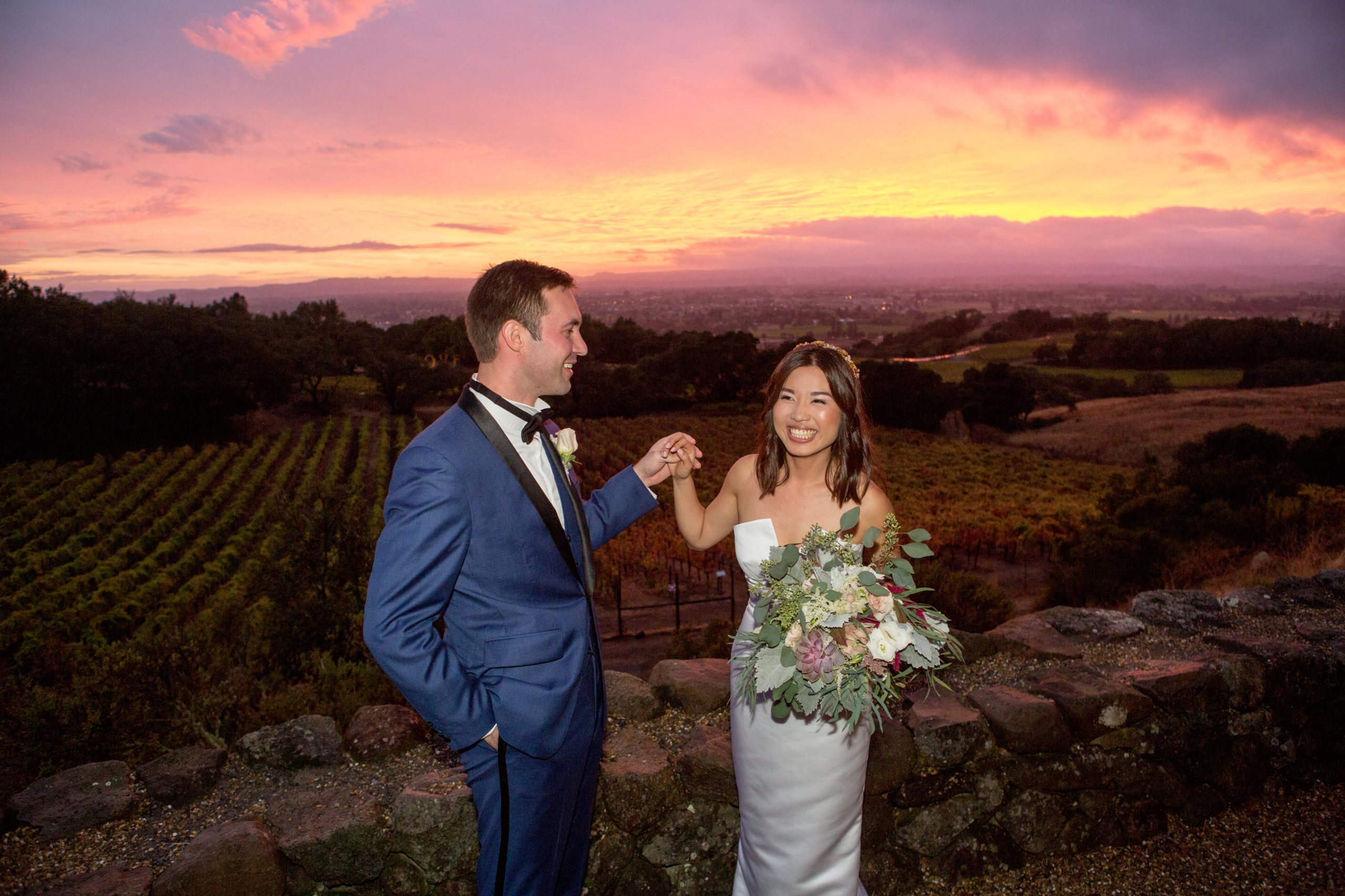 Napa Wedding Venues - Newlyweds in front of vineyards, hills and sunset at Paradise Ridge winery