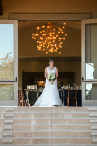 A bride making her ceremony entrance down the grand patio steps at Paradise Ridge winery