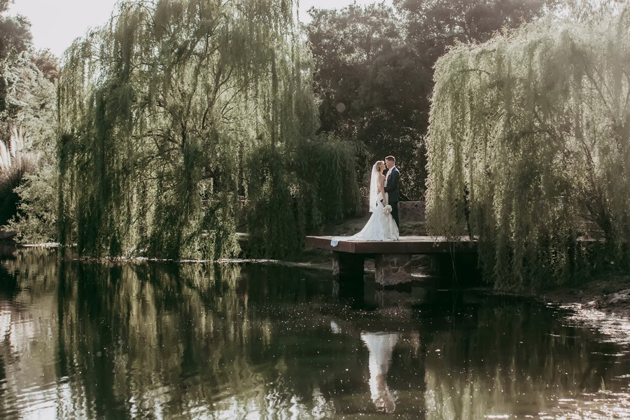 wedding couple at dock on a pond